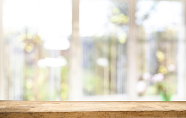 Top of wooden table on window glass blur. Of green from the garden of the vegetable garden on a morning background. To display product montage.