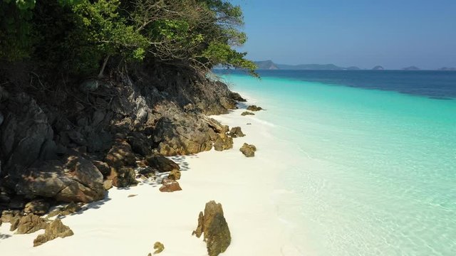 Aerial view of ocean waves, beach and rocky coastline and beautiful forest. Nyaung Oo Phee Island Myanmar