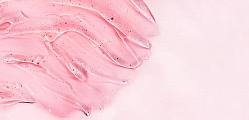 Cosmetic clear liquid transparent cream. Skin care product. Pink background.