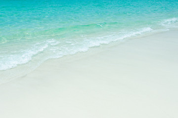 Fototapeta na wymiar Blue sea ocean, water sun reflection, and sand background. Top view
