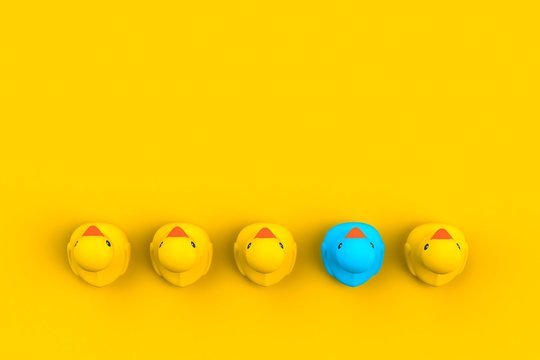 Close up of baby rubber ducks isolated. Bath toys on a yellow background. Top view with copy space. Summer wallpaper. 3d rendering.