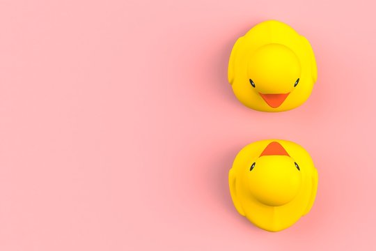 Close up of two rubber ducks isolated. Bath toys on a pink background. Top view with copy space. Summer wallpaper. 3d rendering.