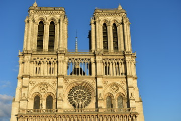 Fototapeta na wymiar Notre-Dame de Paris Cathedral facade closeup at sunset with blue sky. Paris, France.