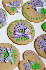 Gingerbread cookies decorated with glaze. On some ribbons tied to a bow. Gingerbread cookies are round and in the shape of a heart. 