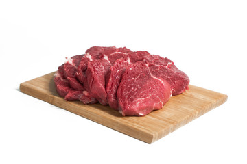 Freshness raw beef in pieces on the cutting board with white background.