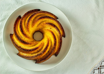 Cornmeal cake. Typical Brazilian cornmeal cake in white porcelain dish in top view