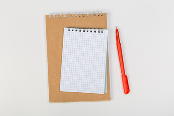 stack of colorful notebooks with pen isolated on white background