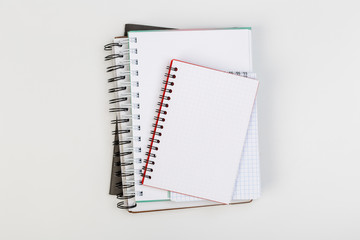 stack of colorful notebooks with pen isolated on white background