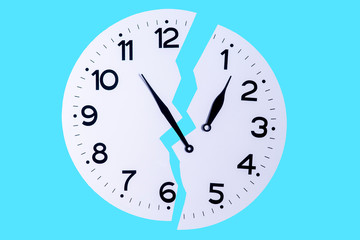 Broken clock on a blue background as a symbol of lack of time
