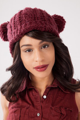 Happy woman in a red knit cap