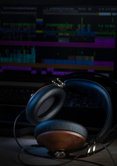 Plakat Hi-Fi headphones and computer in a home-studio audio recording and producing