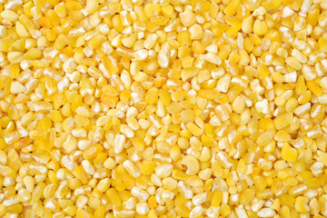 raw crushed corn groats close up