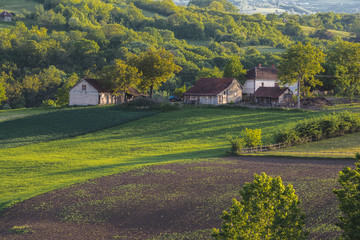 Small farm on a hill at sunset