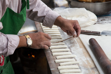 Cook preparing cake batter at a stall on the streets of Phnom Penh