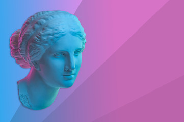 Statue of Venus de Milo. Creative concept colorful neon image with ancient greek sculpture Venus or Aphrodite head. Webpunk, vaporwave and surreal art style. Pink and blue duotone effects. © Ded Pixto