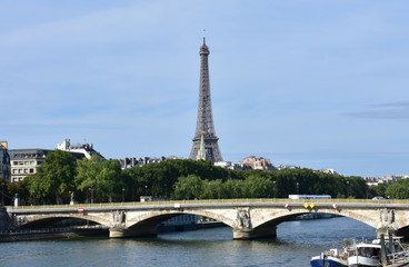 Tour Eiffel and Pont des Invalides with the Seine River on a sunny day. Paris, France.