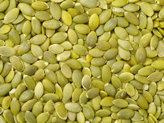 Macro background texture of green pumpkin seeds