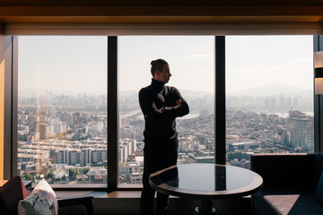 business person in hotel with big window on background