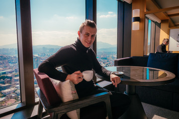 Business man drinks coffee in hotel
