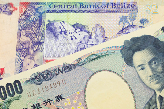 A macro image of a Japanese thousand yen note paired up with a colorful two dollar bill from Belize.  Shot close up in macro.
