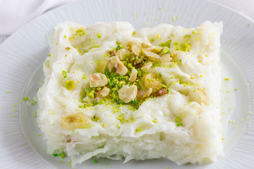 Traditional turkish meal - Gullac. Milk dessert sprinkled with ground nuts and pistachios