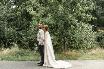 the bride hugs the groom tenderly snuggling up to him,Bride and groom on their wedding day, walking...