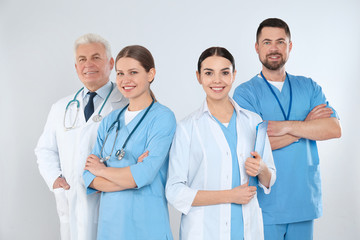 Group of doctors against light background. Medical service