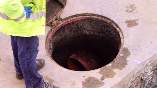 construction  worker cleaning and repairing pipes inside the sewer , video hd footage