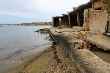 Ruins of abandoned structure by the sea in Attica, Greece, March 2 2020.