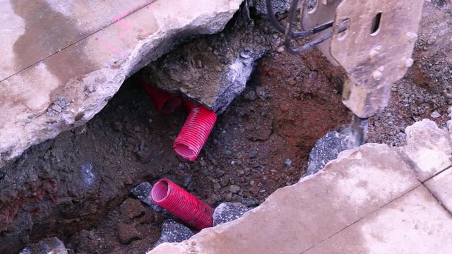 jackhammer  in construction site for restoir and repair pipes for underground electrical wiring conduction , video hd footage