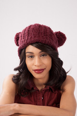 Pleased woman in a red knit cap