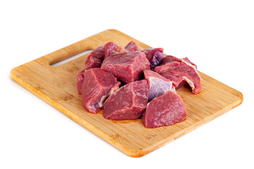 Chopped raw meat on wooden board isolated on white background