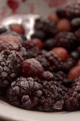 Frozen berries on a plate. Summer fresh berries. Selective focus.