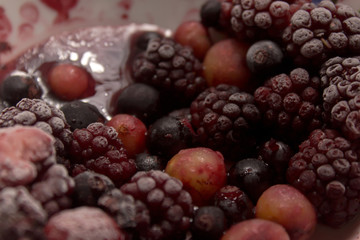 Frozen berries on a plate. Summer fresh berries. Selective focus.