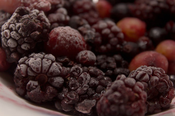 Frozen berries on a plate. Summer fresh berries. Selective focus.