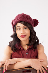 Pleased woman in a red knit cap