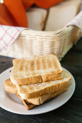 Fresh bread in the basket.Toast is stacked on a plate