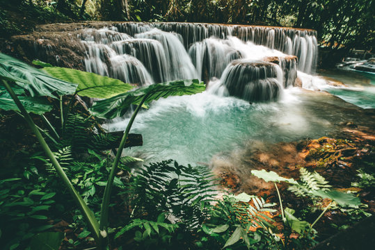 waterfall in the forest with turquoise whater