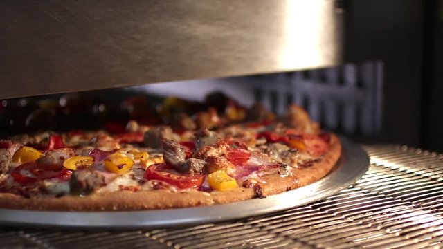 Tasty hot pizza coming from the oven