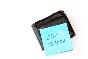 Searching a work, last money, poverty, unemployment, job loss concept. Flat lay. Notebook with job search phrase and old shabby wallet purse, on white background.