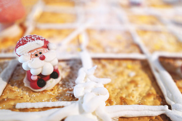 Santa Claus doll on biscuit with bread background.Festive season Christmas and New Year