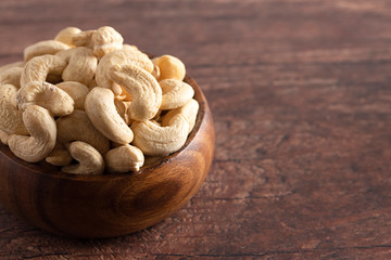 Bowl of Raw Natural Cashews  on a Wooden Table