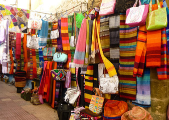 Market with colourful bags and scarves