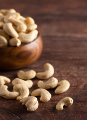 Bowl of Raw Natural Cashews  on a Wooden Table