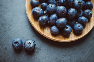 Blueberries on a dark background on a plate