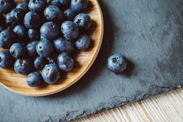 Blueberries on a dark background on a plate