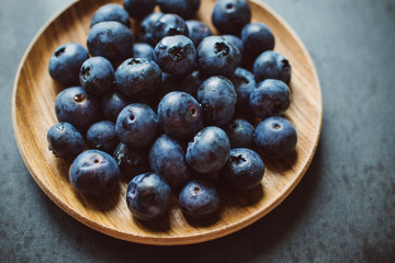 Blueberries on a dark background on a plate