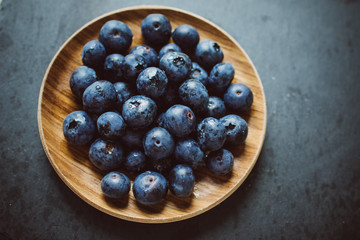 Blueberries on a dark background on a plate