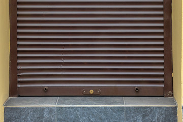Entrance with closed blind. Close up.