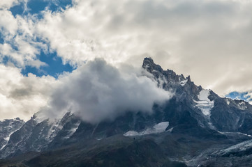 French Alps mountains in a cloudy summer day, seen from Chamonix, Haute Savoy, France.